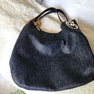 Dark navy leather shoulder bag with brass detail